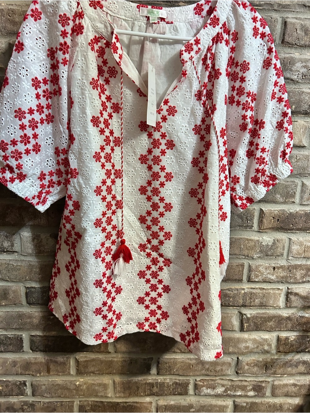 Jade Melody Tam;White Eyelet Blouse with Red Floral Embroidery and Tasseled Ties